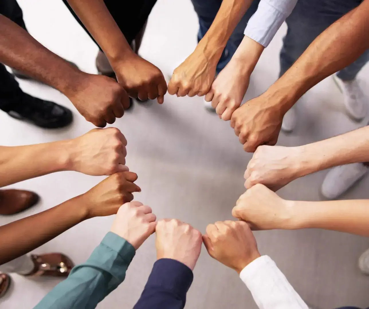 Hands forming a unity circle together.